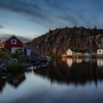 Quidi Vidi fishing village is bathed in a warm golden glow at sunset, highlighting the charming coastal scenery of eastern Newfoundland. Photography with Roland Bast Photo