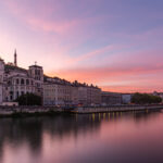 Sunset over the Saone River in Lyon, France, casting a warm glow on the water.