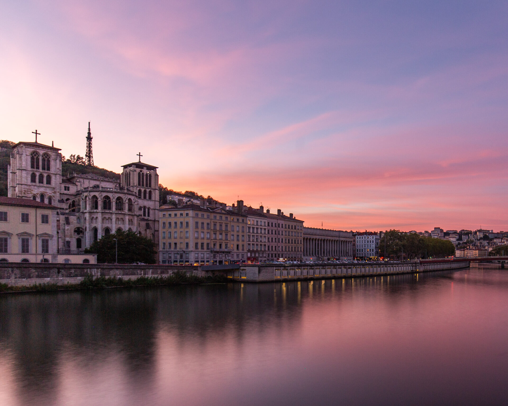 Sunset over the Saone River in Lyon, France, casting a warm glow on the water.