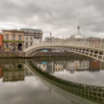 Ha'penny Bridge in Dublin, one of the oldest footbridges over the Liffey River, captured at dusk, and with Go Colette Tours