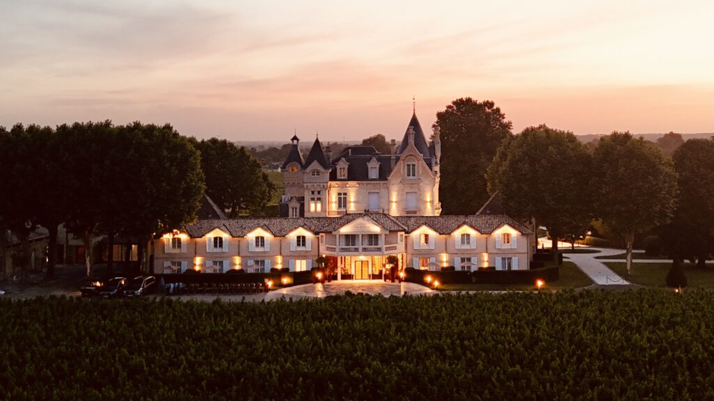Drone view at sunset of the front of Hôtel Grand Barrail in Saint-Émilion, France